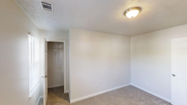 364 Springhaven Way, Lawrenceville, GA 30046 - unfurnished bedroom featuring carpet flooring, a textured ceiling, and a closet
