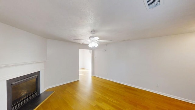 364 Springhaven Way, Lawrenceville, GA 30046 - unfurnished living room with ceiling fan, a glass covered fireplace, and wood finished floors