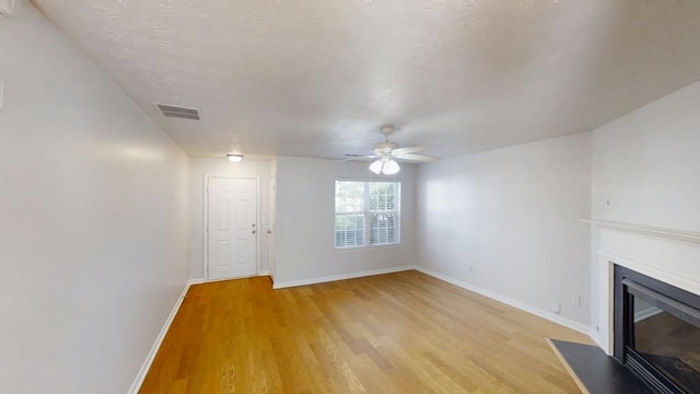 364 Springhaven Way, Lawrenceville, GA 30046 - unfurnished living room with ceiling fan, a fireplace with flush hearth, and light wood-style floors