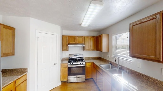 364 Springhaven Way, Lawrenceville, GA 30046 - kitchen featuring stainless steel gas stove, under cabinet range hood, light wood finished floors, and brown cabinetry