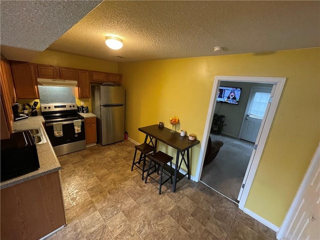 kitchen featuring stainless steel appliances and a textured ceiling