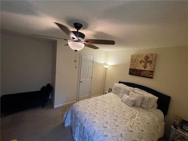 carpeted bedroom with ceiling fan and a textured ceiling