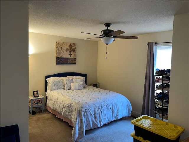 carpeted bedroom featuring a textured ceiling and ceiling fan