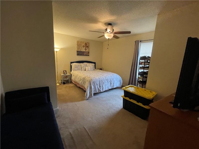 carpeted bedroom with a textured ceiling and ceiling fan