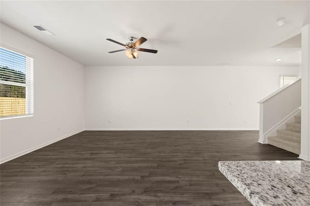 unfurnished room featuring dark wood-type flooring and ceiling fan