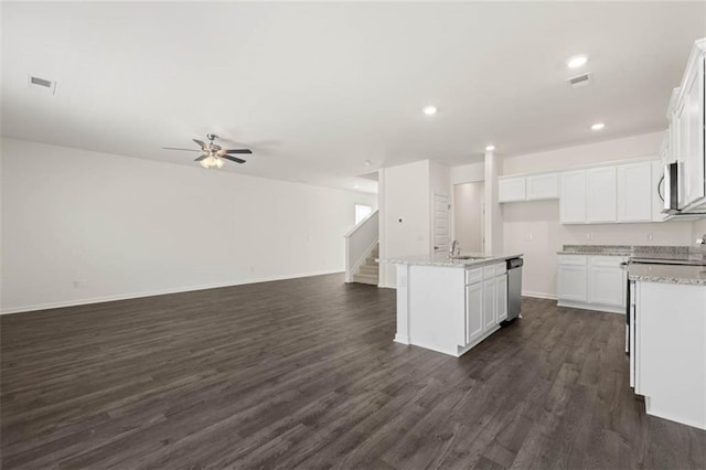 kitchen featuring appliances with stainless steel finishes, dark hardwood / wood-style floors, white cabinetry, a kitchen island with sink, and ceiling fan