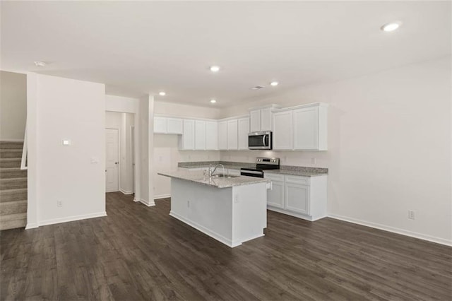 kitchen featuring sink, white cabinetry, dark hardwood / wood-style flooring, an island with sink, and stainless steel appliances