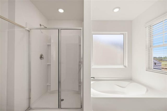 bathroom with shower with separate bathtub