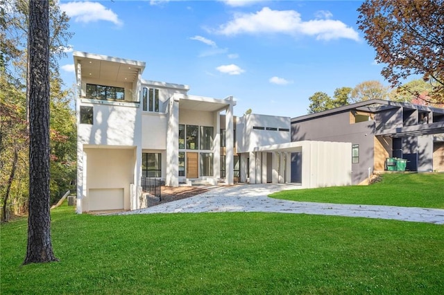 back of house featuring a patio and a lawn