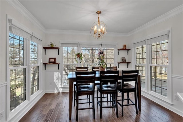 dining space with dark wood finished floors, crown molding, a notable chandelier, and a wealth of natural light