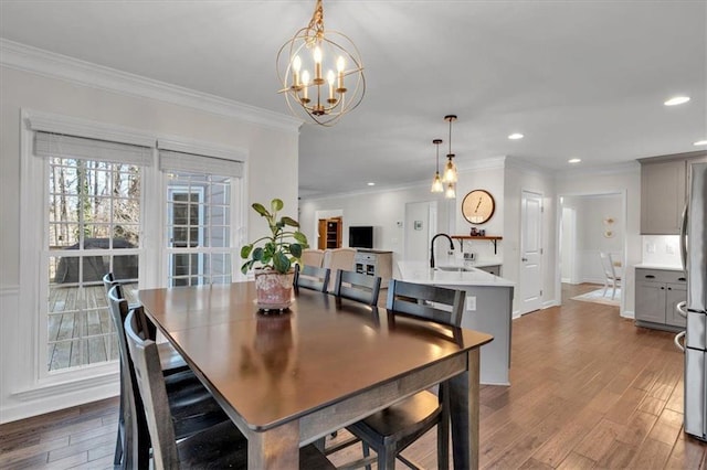 dining space featuring a notable chandelier, recessed lighting, crown molding, and dark wood-type flooring