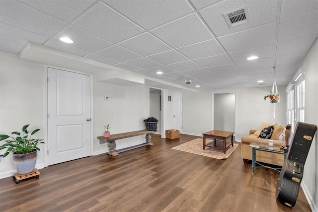 living room with visible vents, baseboards, and wood finished floors