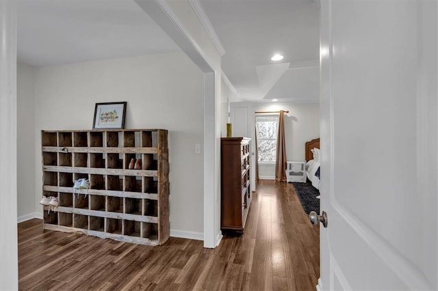 hallway featuring recessed lighting, ornamental molding, baseboards, and wood finished floors