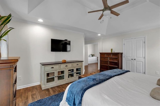 bedroom with baseboards, lofted ceiling, ornamental molding, recessed lighting, and wood finished floors