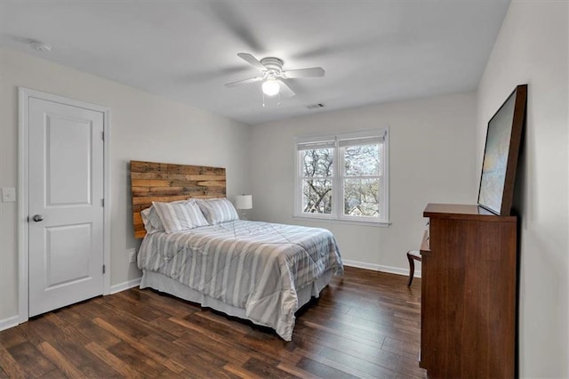 bedroom featuring a ceiling fan, visible vents, dark wood-style flooring, and baseboards