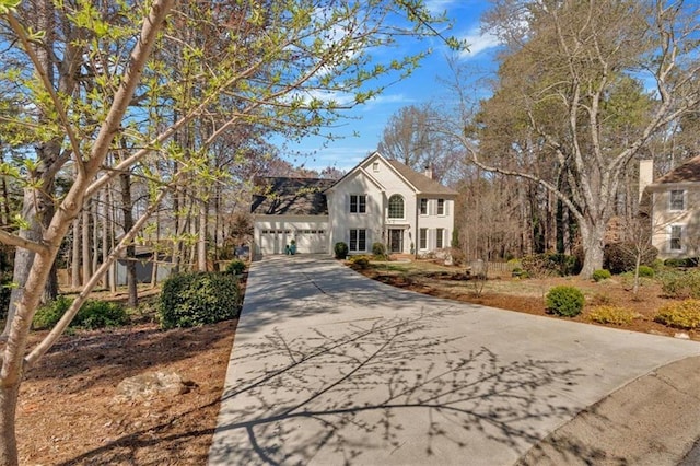 view of front of house with concrete driveway and a garage