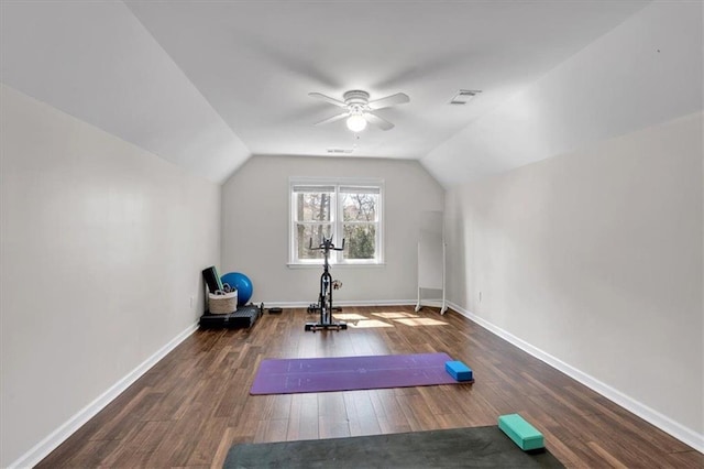 exercise room with visible vents, baseboards, lofted ceiling, hardwood / wood-style floors, and a ceiling fan