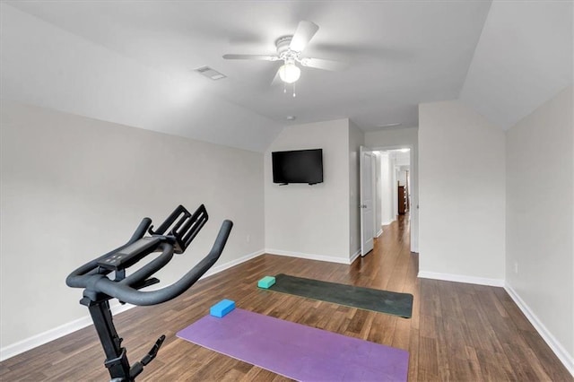 workout room featuring ceiling fan, baseboards, wood finished floors, and vaulted ceiling