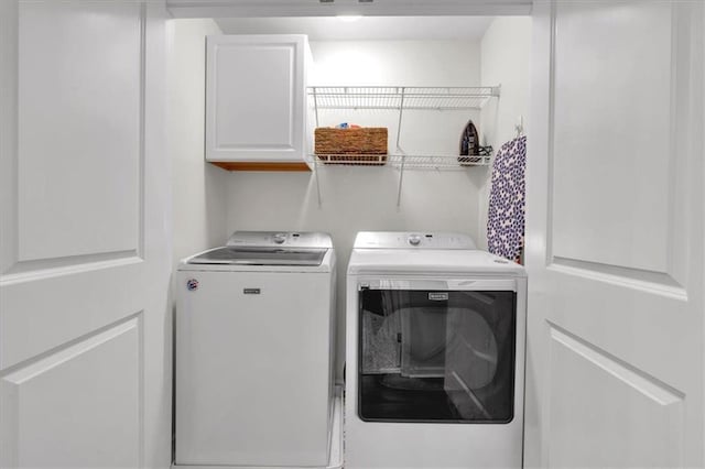 laundry room with cabinet space and independent washer and dryer