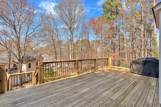 wooden terrace featuring a grill