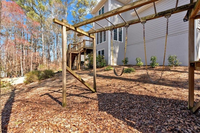 view of side of home featuring stairway and a wooden deck