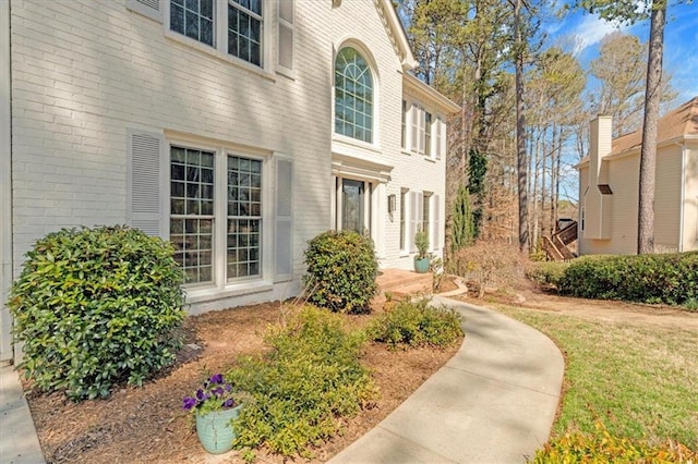 view of exterior entry with brick siding