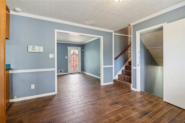 empty room featuring ornamental molding and dark hardwood / wood-style flooring