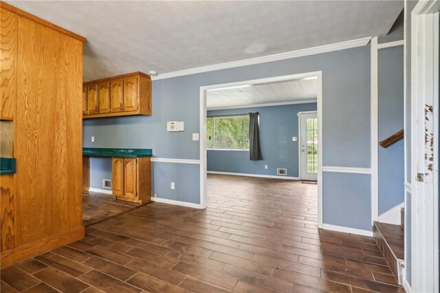 kitchen featuring crown molding and dark hardwood / wood-style flooring