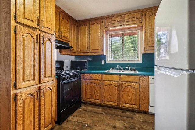 kitchen featuring dark hardwood / wood-style floors, sink, black range with gas stovetop, and white refrigerator