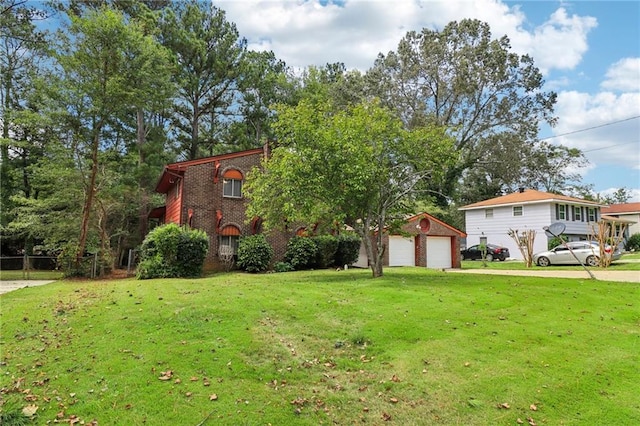 view of front of home featuring a front yard, a garage, and an outbuilding