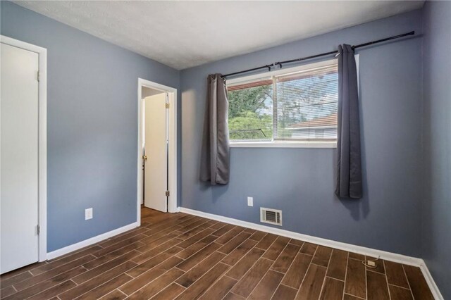 spare room featuring dark hardwood / wood-style flooring