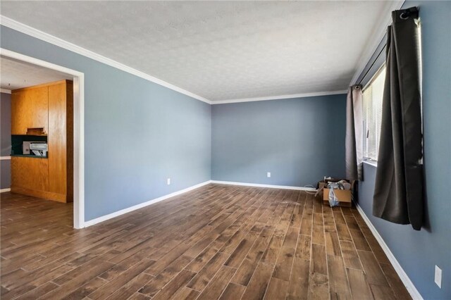 unfurnished room with ornamental molding and dark wood-type flooring