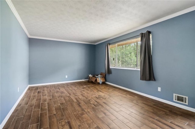 spare room featuring a textured ceiling, crown molding, and dark hardwood / wood-style flooring