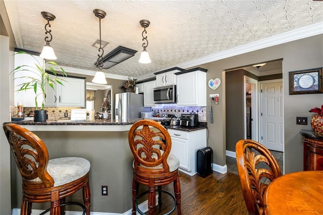 7282 Litany Ct, Flowery Branch, GA 30542 - kitchen featuring appliances with stainless steel finishes, a breakfast bar area, dark wood finished floors, backsplash, and white cabinets