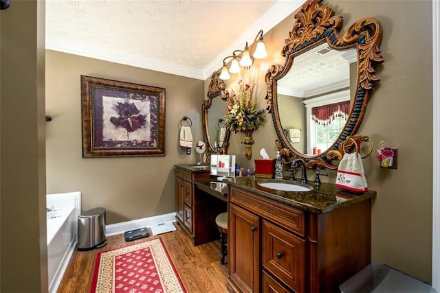 7282 Litany Ct, Flowery Branch, GA 30542 - full bathroom with vanity, wood finished floors, a garden tub, ornamental molding, and baseboards