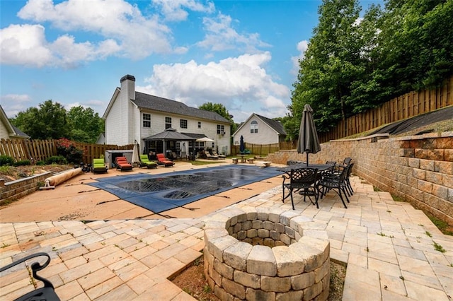 7282 Litany Ct, Flowery Branch, GA 30542 - view of swimming pool featuring a patio, a gazebo, a fire pit, a fenced backyard, and a diving board