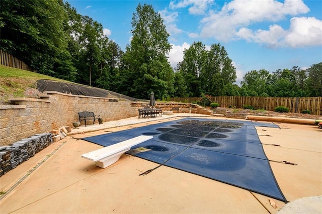 7282 Litany Ct, Flowery Branch, GA 30542 - view of swimming pool with a diving board, a patio, and a fenced backyard