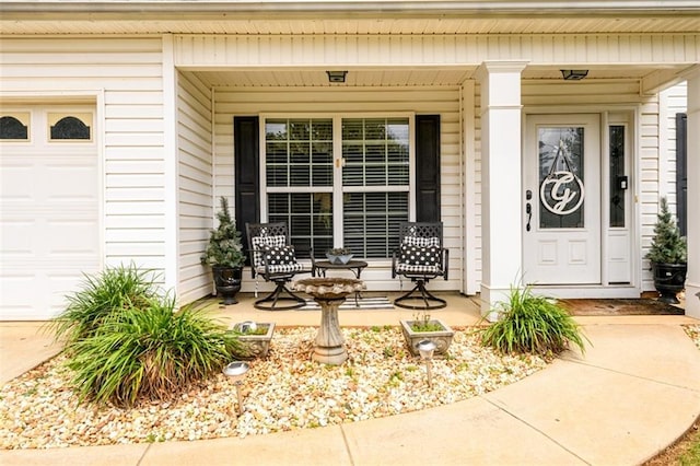 7282 Litany Ct, Flowery Branch, GA 30542 - view of exterior entry with covered porch and a garage