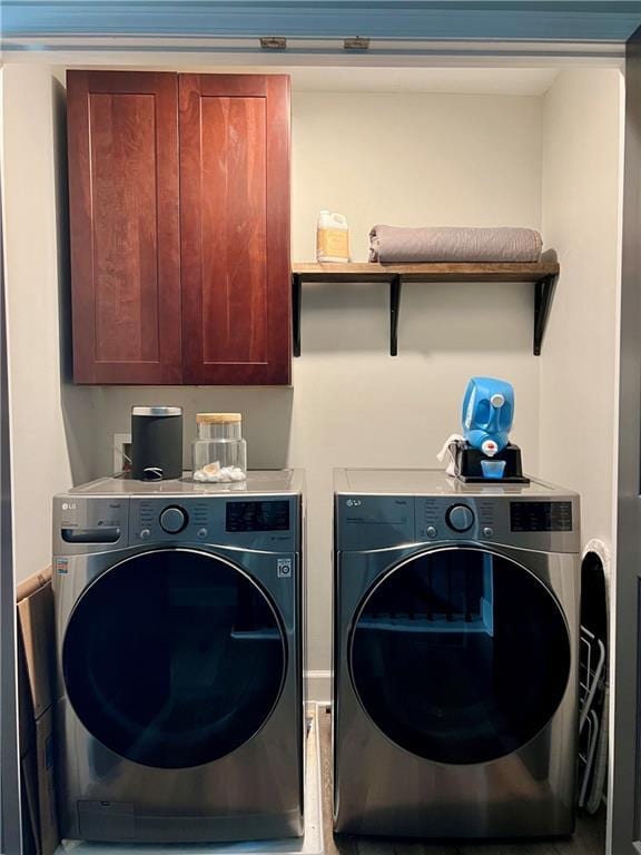 laundry area featuring cabinets and washing machine and clothes dryer