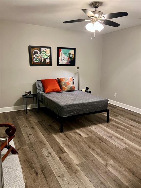 bedroom featuring hardwood / wood-style floors and ceiling fan