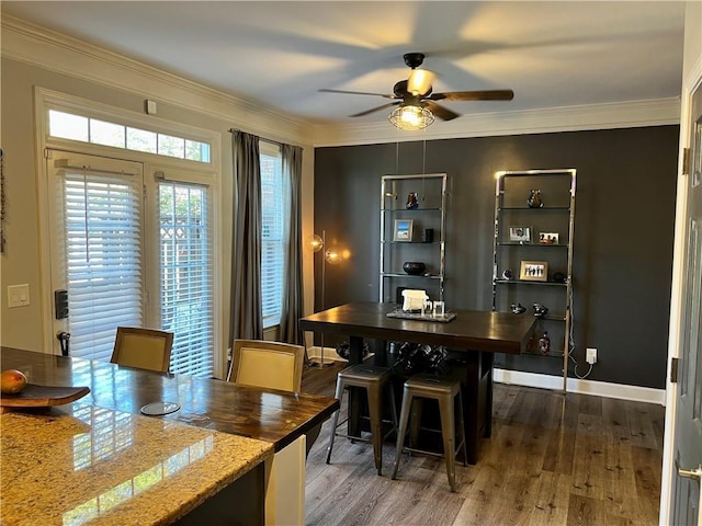 dining room with ceiling fan, dark hardwood / wood-style flooring, and crown molding