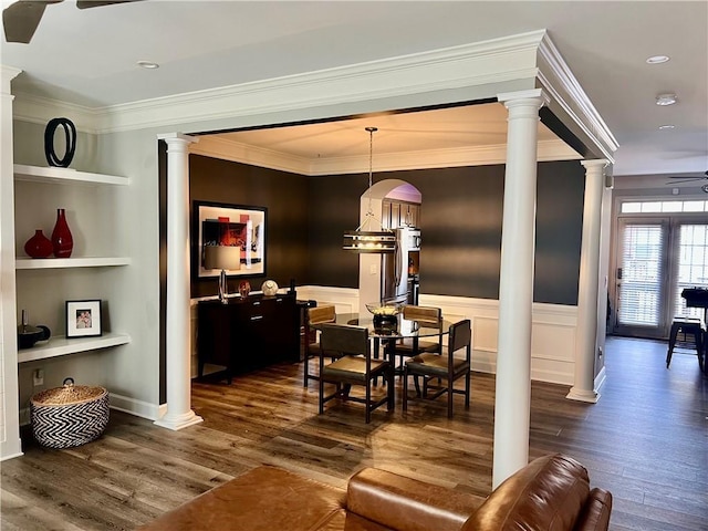 dining space with dark hardwood / wood-style flooring, built in features, ceiling fan, and ornamental molding