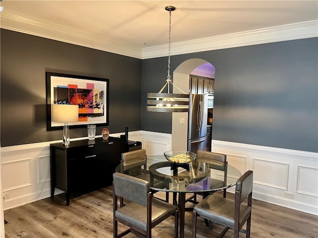 dining space featuring hardwood / wood-style floors and ornamental molding