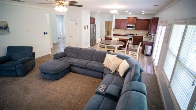 living room featuring crown molding, ceiling fan, and wood-type flooring