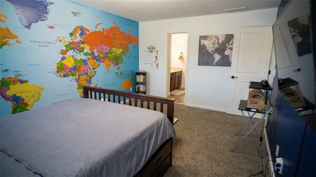 bedroom with dark colored carpet and ensuite bathroom