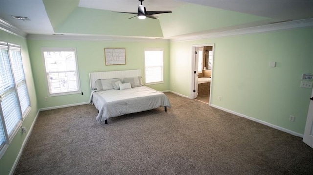 carpeted bedroom featuring ceiling fan, a raised ceiling, connected bathroom, ornamental molding, and vaulted ceiling