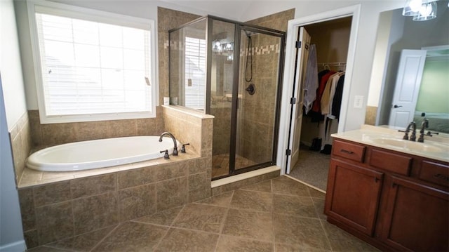 bathroom with plus walk in shower, vanity, and plenty of natural light