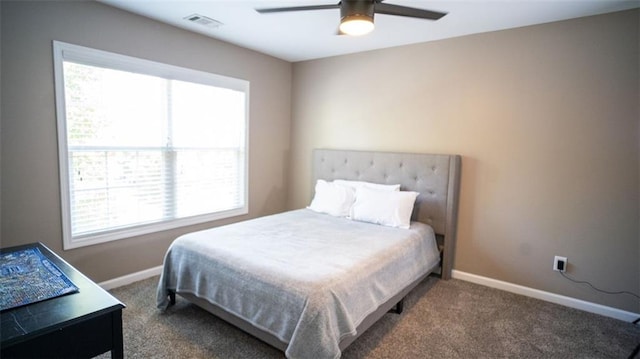 bedroom featuring ceiling fan and dark carpet