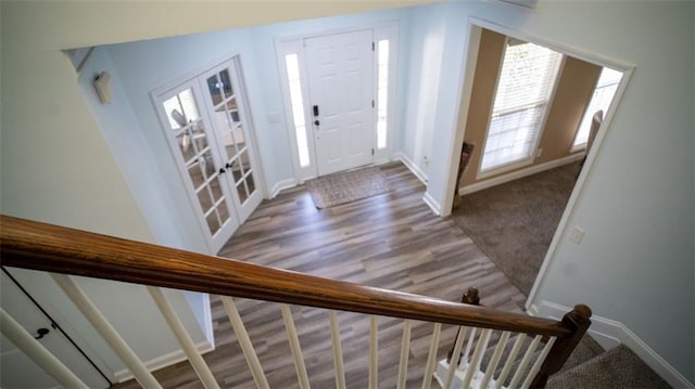 entryway with plenty of natural light, french doors, and wood-type flooring