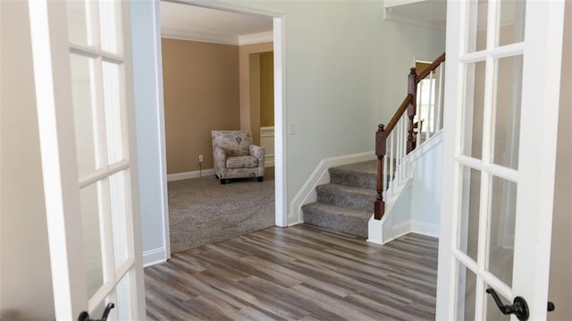 entryway with crown molding, hardwood / wood-style floors, and french doors